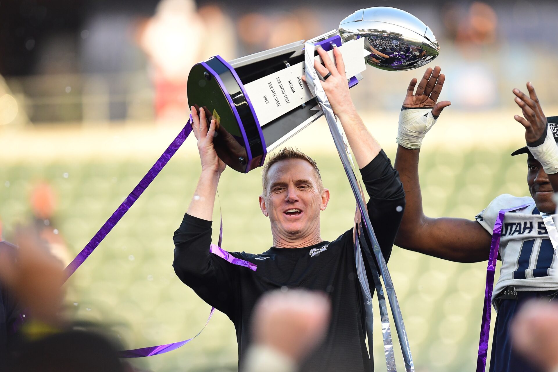 Blake Anderson lifts the champions trophy following the victory against San Diego State Aztecs in the Mountain West Conference Championship Game.