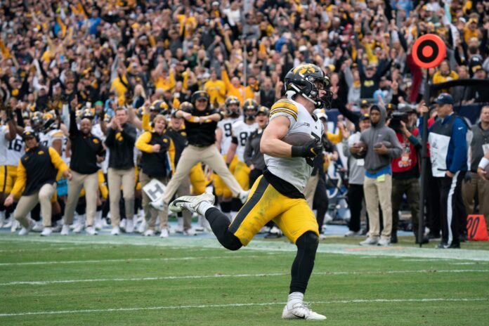 Cooper DeJean of the Iowa Hawkeyes races up the field with an interception for a touchdown.
