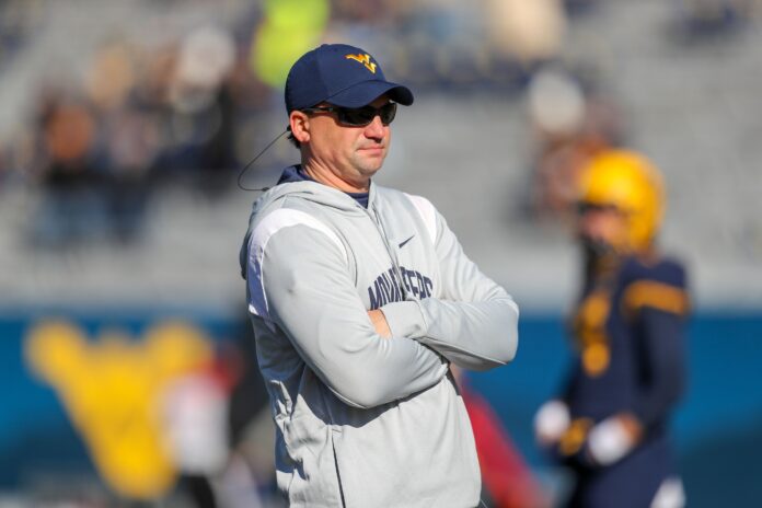 Neal Brown during warmups before their game against the Kansas State Wildcats.