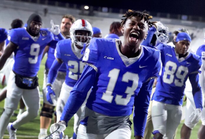 Middle Tennessee WR Javonte Sherman (13) celebrates with teammates after a win.