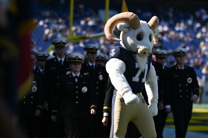 Navy mascot Bill the Goat leads the brigade of midshipmen onto the field.