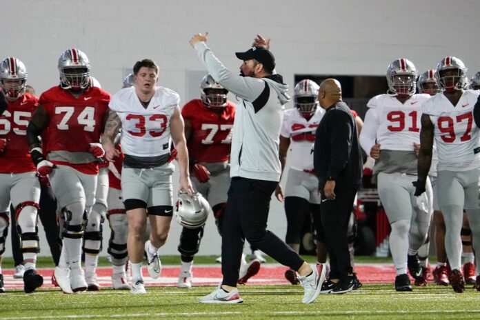 Ohio State head coach Ryan Day gathers his team around during spring practice.