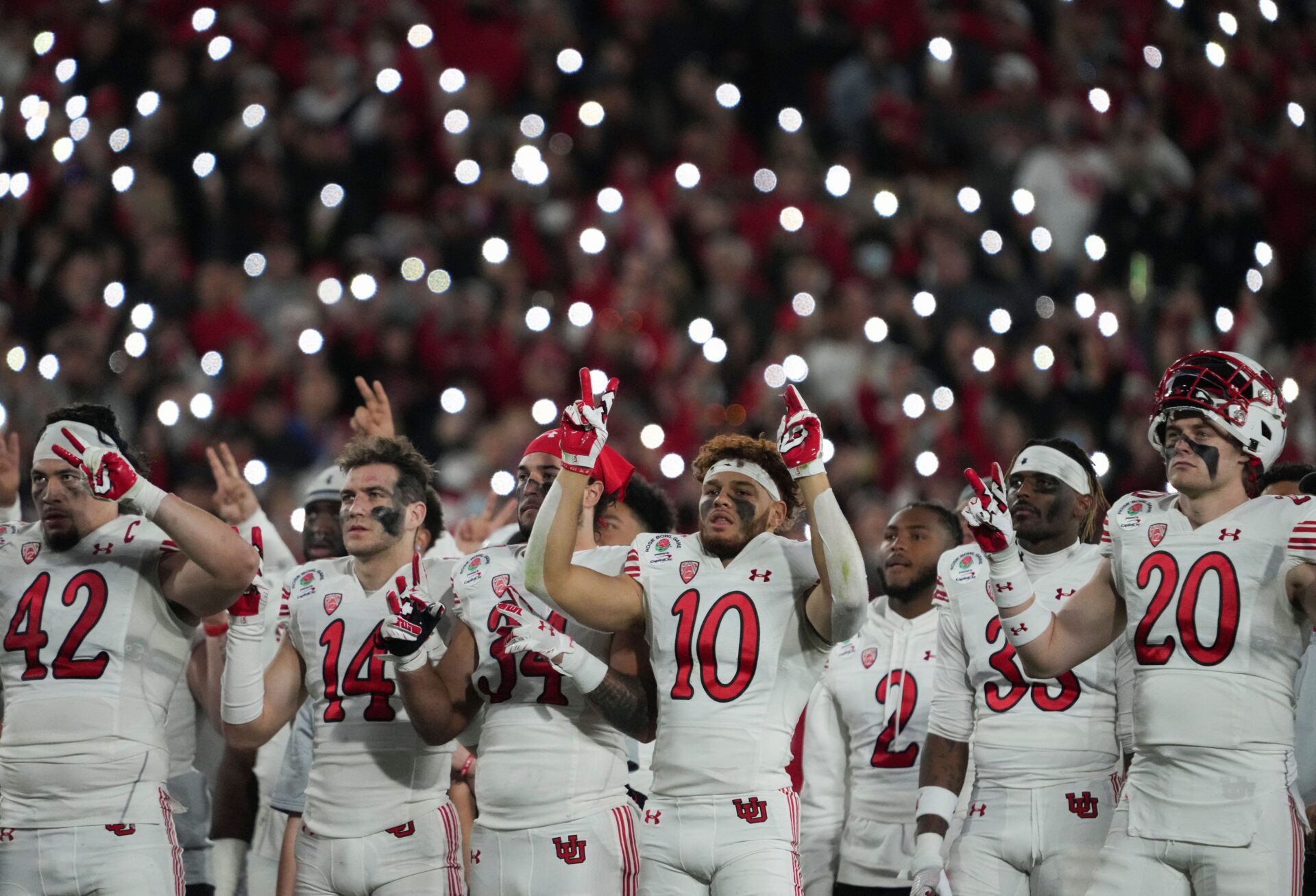 Utah Utes players watch a video presentation dedicated to the lives of Ty Jordan and Aaron Lowe.