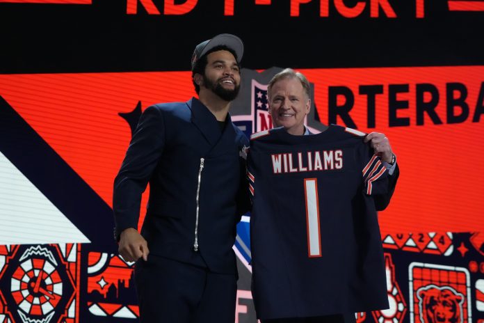 Southern California Trojans quarterback Caleb Williams poses with NFL commissioner Roger Goodell after being selected by the Chicago Bears as the No. 1 pick in the first round of the 2024 NFL Draft at Campus Martius Park and Hart Plaza.