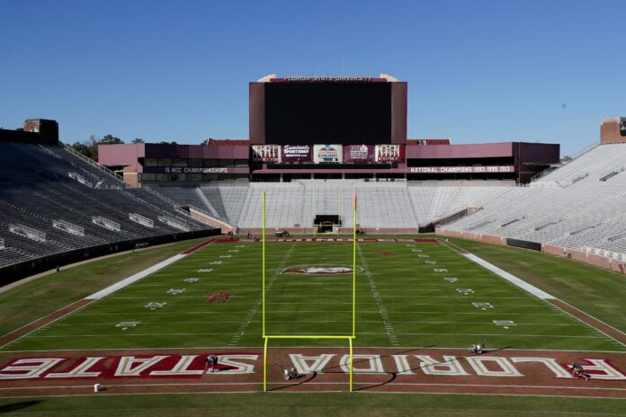 A crew paints Bobby Bowden Field at Doak Campbell Stadium.