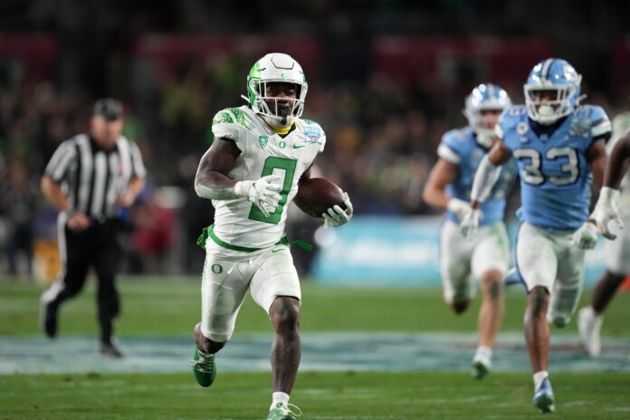 Oregon RB Bucky Irving (0) scores a long touchdown against North Carolina.