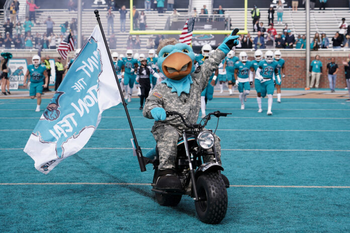 Nov 20, 2021; Conway, South Carolina, USA; Coastal Carolina Chanticleers mascot Chauncey leads the team onto the field before a game against the Texas State Bobcats at Brooks Stadium. Mandatory Credit: David Yeazell-USA TODAY Sports\