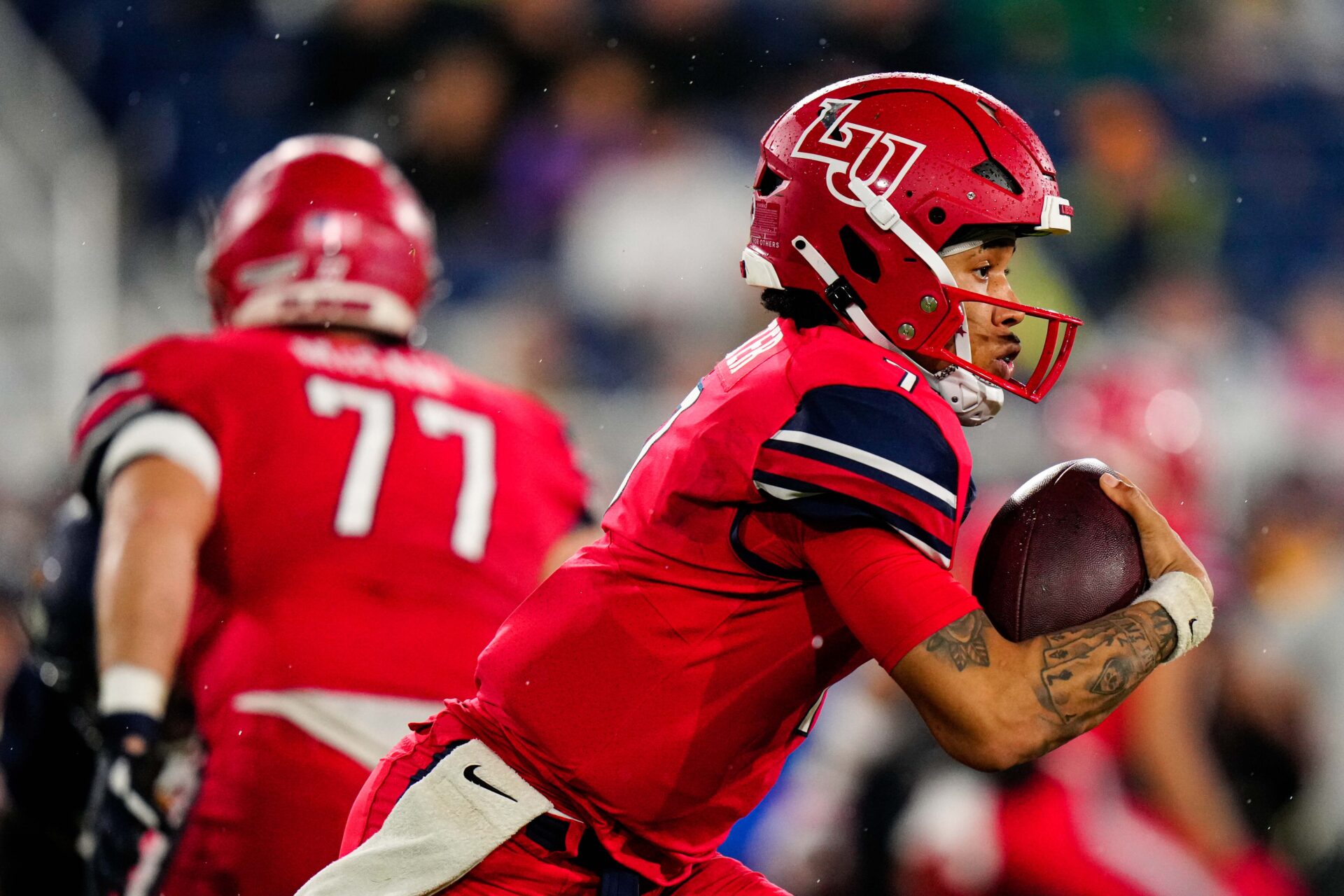 Dec 20, 2022; Boca Raton, Florida, USA; Liberty Flames quarterback Kaidon Salter (7) runs the ball against the Toledo Rockets during the second half in the 2022 Boca Raton Bowl at FAU Stadium. Mandatory Credit: Rich Storry-USA TODAY Sports