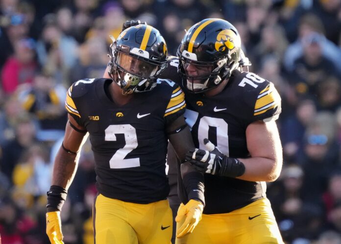 Iowa offensive lineman Beau Stephens (70) celebrates with running back Kaleb Johnson in the second quarter against Nebraska during a NCAA football game on Friday, Nov. 25, 2022, at Kinnick Stadium in Iowa City. Iowavsneb 20221125 Bh