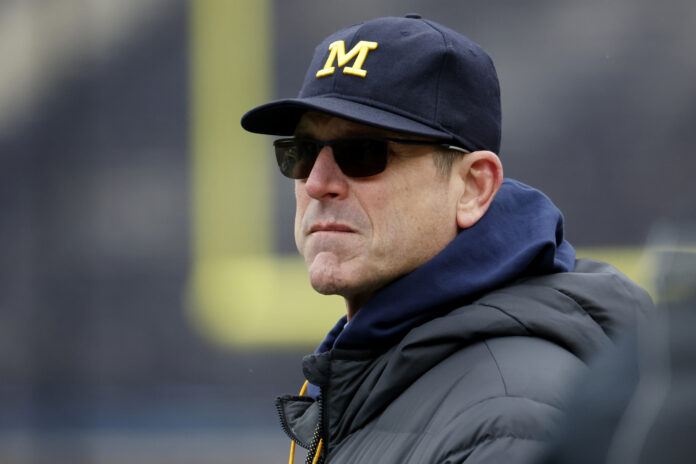 Jim Harbaugh leads the Michigan Wolverines coaching staff
