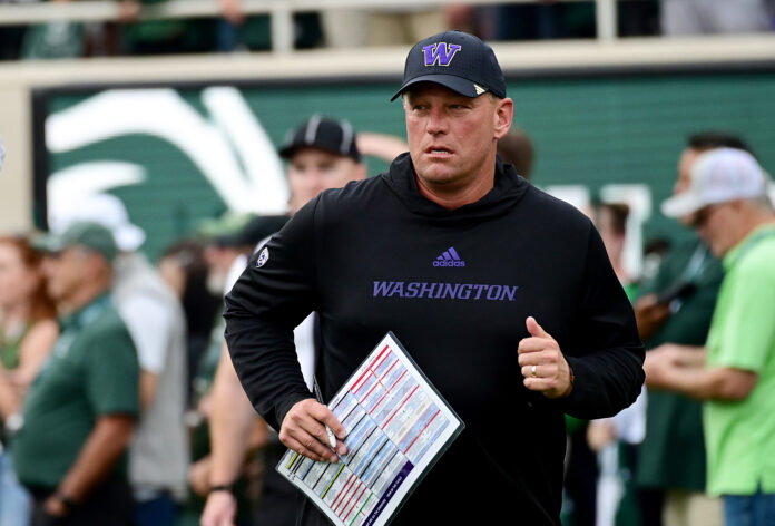 Washington Huskies head coach Kalen DeBoer runs onto the field for the game against the Michigan State Spartans at Spartan Stadium.