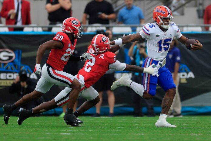 Florida Gators quarterback Anthony Richardson (15) fends off Georgia Bulldogs linebacker Smael Mondon Jr. (2) before being forced out of bounds during the first quarter of an NCAA football game Saturday, Oct. 29, 2022 at TIAA Bank Field in Jacksonville. The Georgia Bulldogs outlasted the Florida Gators 42-20.