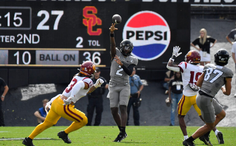 Colorado Buffaloes quarterback Shedeur Sanders (2) throws a pass intended for Colorado Buffaloes tight end Michael Harrison (87) as USC Trojans linebacker Mason Cobb (13) and USC Trojans safety Jaylin Smith (19) defend on the play in the second quarter at Folsom Field.