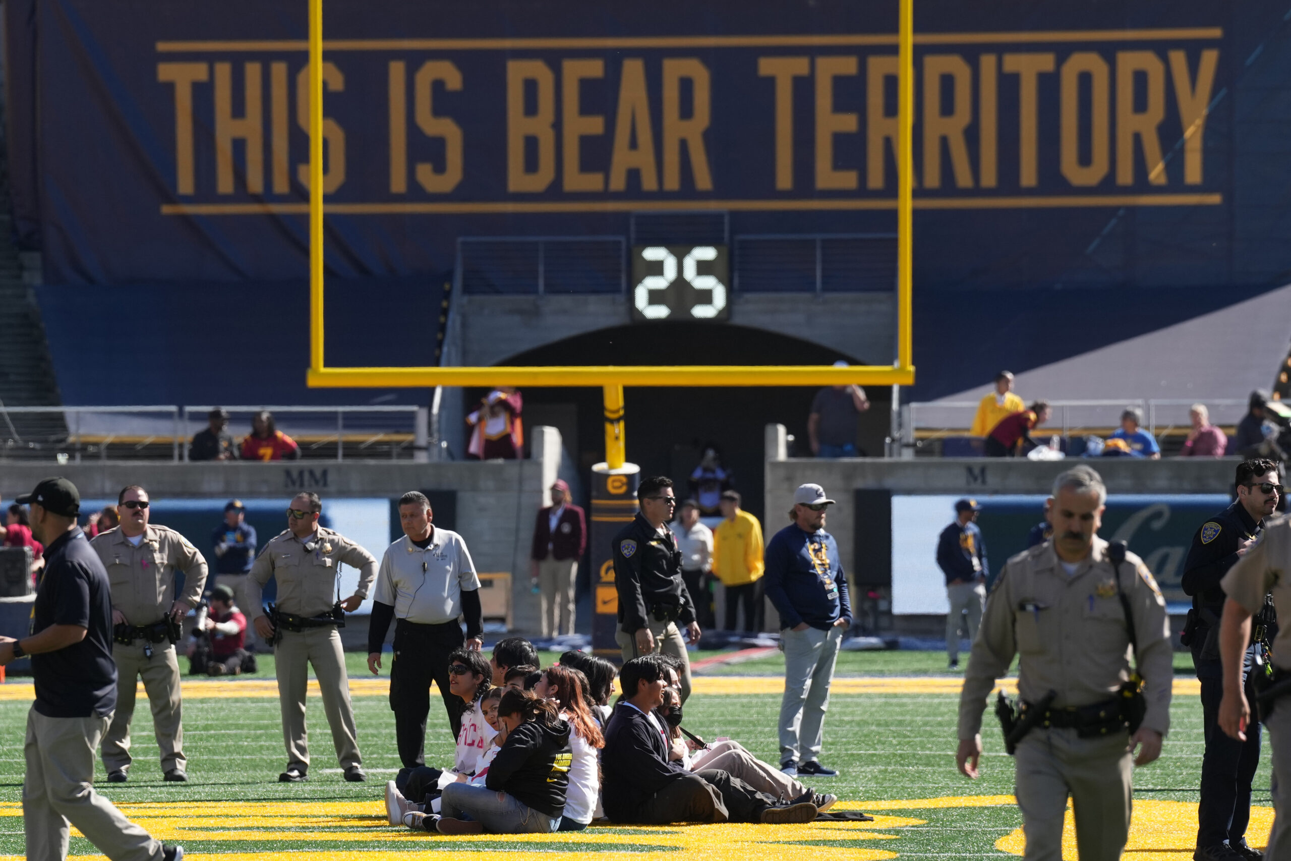 Protestors took to the field to delay the kickoff of the USC-Cal game in protest of the suspended Ivonne del Valle, a UC Berkeley professor.