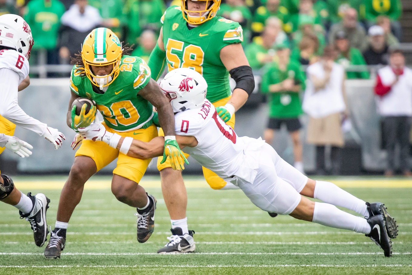 Oregon running back Jordan James sheds a tackle from Washington State's Sam Lockett III as the No. 9 Oregon Ducks host Washington State.