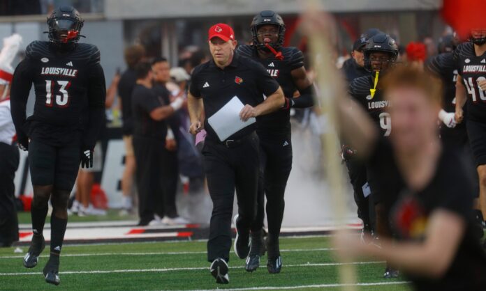 Louisville s Jeff Brohm runs out of the tunnel against Murray on Thursday, Sept. 7, 2023.