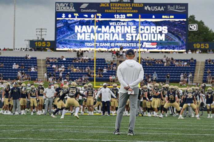 Navy Midshipmen head coach Brian Newberry looks on as his team warms up before the game against the Wagner Seahawks at Navy-Marine Corps Memorial Stadium.