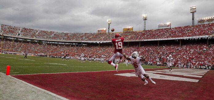 Oklahoma's #19, Justin Brown, goes up for a touchdown catch as Texas #6, Quandre Diggs, tries to defend during the second half of action in the Red River Rivalry held at the Cotton Bowl in Dallas, Texas.