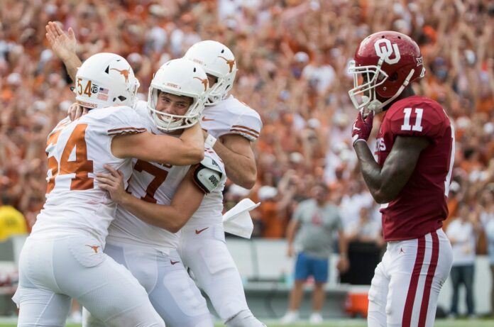 Texas Longhorns place kicker Cameron Dicker (17) celebrates with teammates after kicking the winning field goal 48-45 against Oklahoma Sooners.