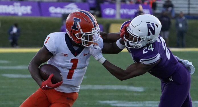 Northwestern Wildcats defensive back Rod Heard II (24) tries to tackle Illinois Fighting Illini wide receiver Isaiah Williams (1) during the first half at Ryan Field.