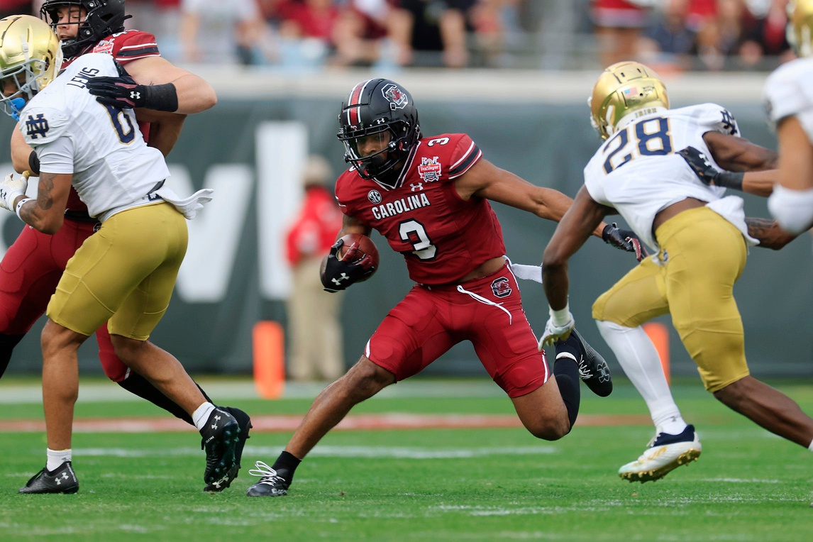 South Carolina Gamecocks wide receiver Antwane Wells Jr. (3) rushes for yards against Notre Dame Fighting Irish cornerback TaRiq Bracy (28) during the first quarter of the TaxSlayer Gator Bowl of an NCAA college football game Friday, Dec. 30, 2022 at TIAA Bank Field in Jacksonville. The Notre Dame Fighting Irish held off the South Carolina Gamecocks 45-38.