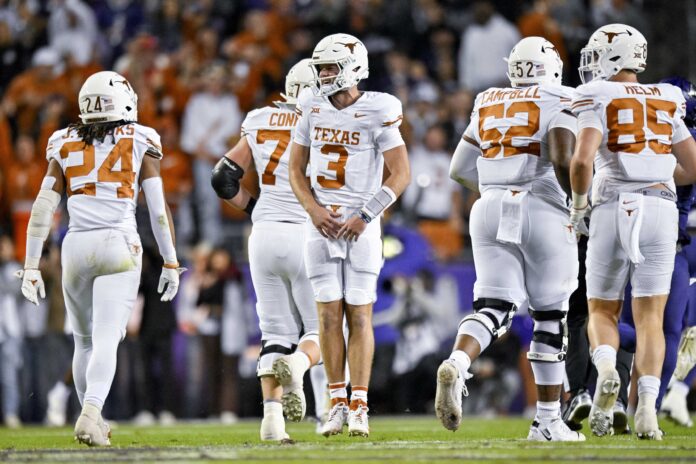 Texas Longhorns quarterback Quinn Ewers (3) celebrates with this teammates during the first half against the TCU Horned Frogs at Amon G. Carter Stadium.
