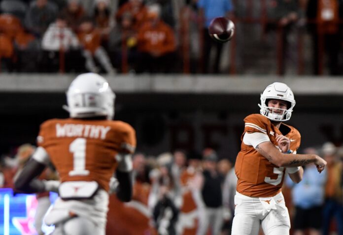 Texas' quarterback Quinn Ewers (3) throws the ball to Texas' wide receiver Xavier Worthy (1) during the game against Texas Tech.