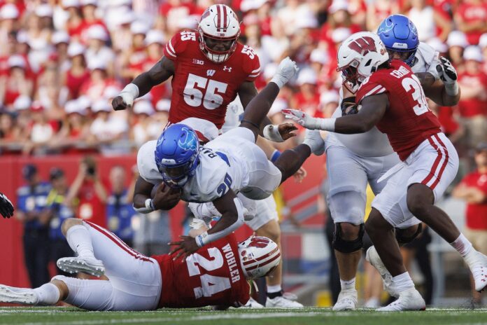 Buffalo Bulls running back Jacqez Barksdale (20) is tackled during the fourth quarter against the Wisconsin Badgers at Camp Randall Stadium.