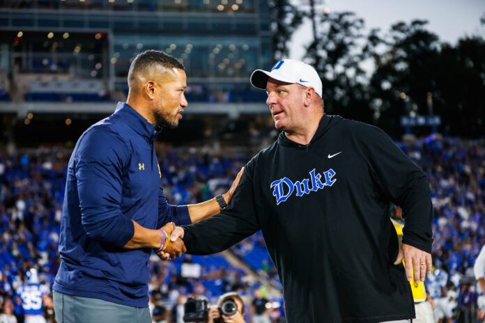 Duke Blue Devils head coach Mike Elko and Notre Dame Fighting Irish head coach Marcus Freeman meet just before the game at Wallace Wade Stadium.
