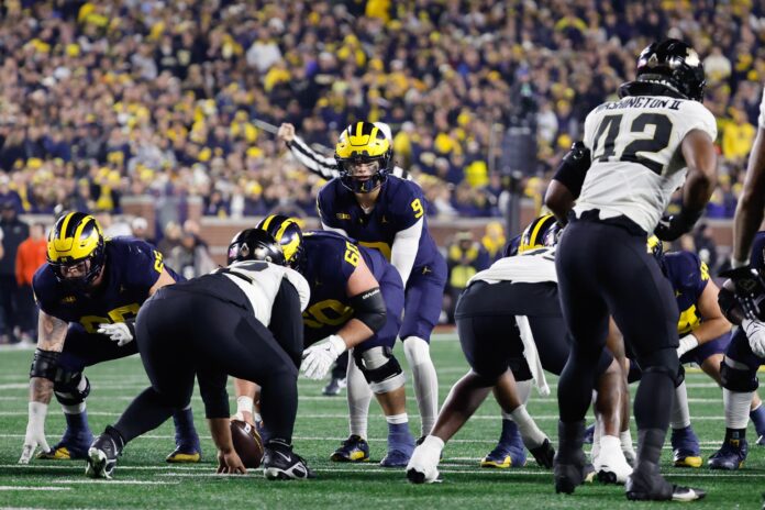 Michigan Wolverines quarterback J.J. McCarthy (9) gets set to run a play against the Purdue Boilermakers in the first half at Michigan Stadium.