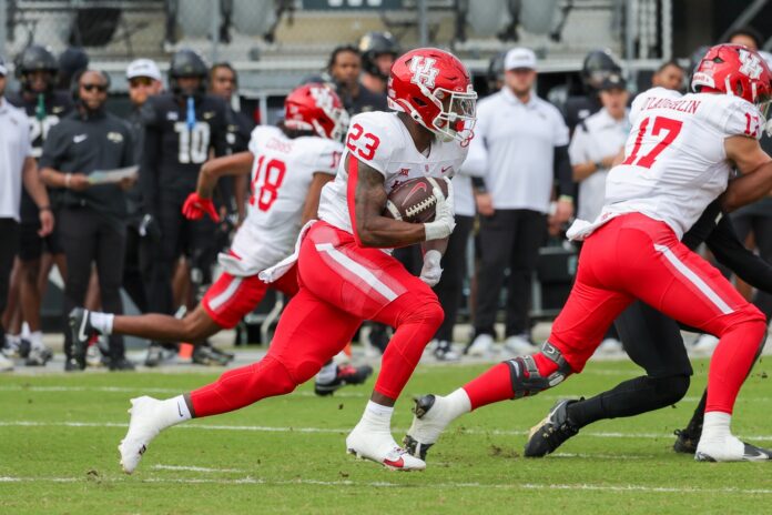 Houston Cougars running back Parker Jenkins (23) carries the ball during the first quarter against the UCF Knights at FBC Mortgage Stadium.