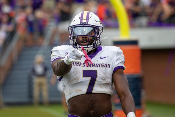 James Madison Dukes running back Ty Son Lawton (7) points at the camera after scoring a touchdown against the Virginia Cavaliers during the second half at Scott Stadium.