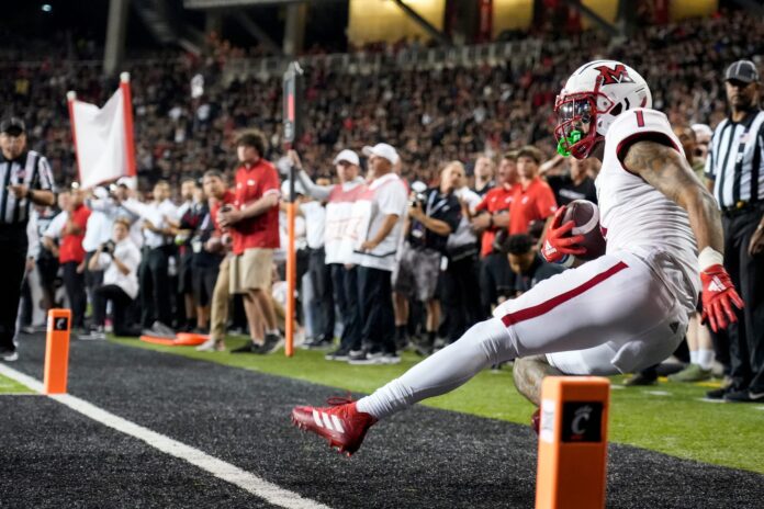 Miami (Oh) RedHawks wide receiver Joe Wilkins Jr. (1) scores a touchdown during overtime.