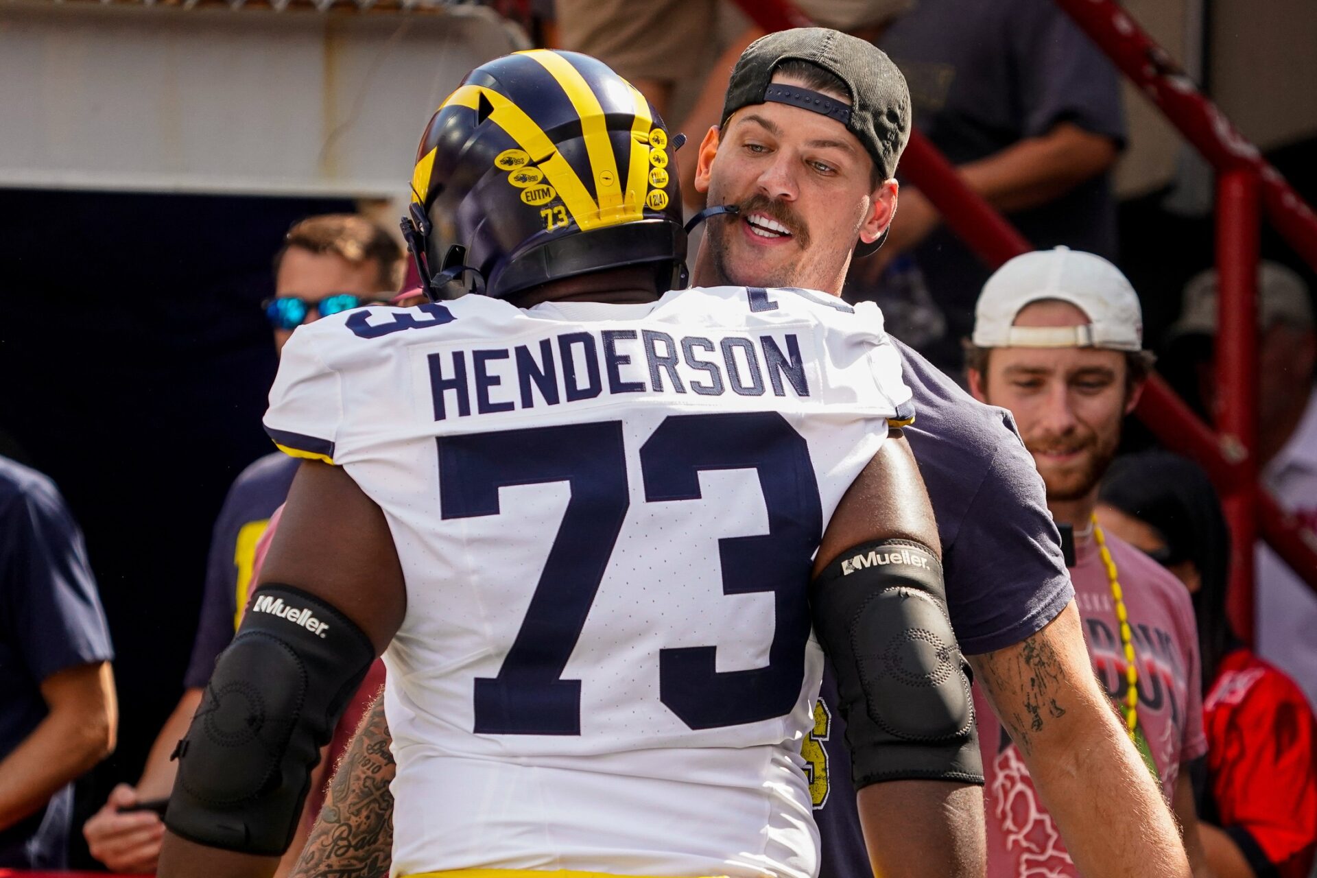 Taylor Lewan greets Michigan Wolverines offensive lineman LaDarius Henderson (73) before the game against the Nebraska Cornhuskers.
