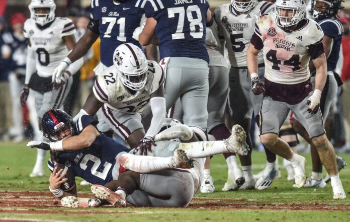 Ole Miss QB Jaxson Dart (2) is tackled by Mississippi State DT Nathan Pickering (22) at the 2022 Egg Bowl at Ole Miss' Vaught-Hemingway Stadium.