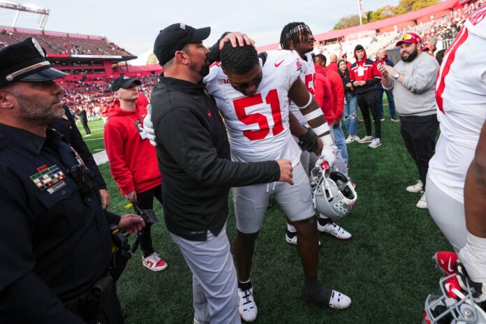 Ohio State Buckeyes head coach Ryan Day hugs defensive tackle Michael Hall Jr. (51) following the NCAA football game against the Rutgers Scarlet Knights.