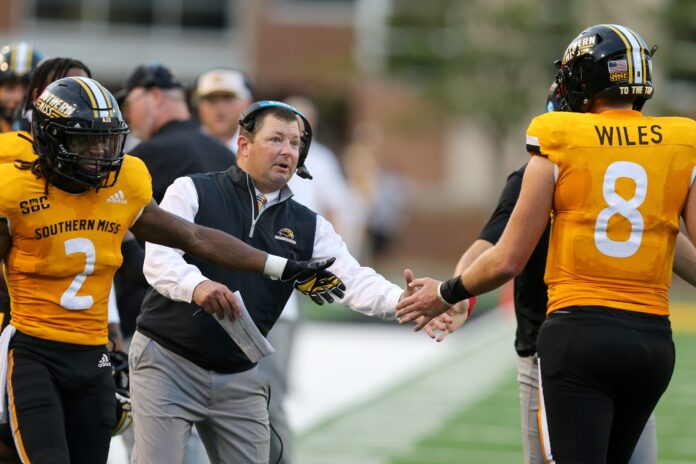 Southern Miss Golden Eagles head coach Will Hall congratulates quarterback Billy Wiles (8) after a second quarter touchdown against the Alcorn State Braves.