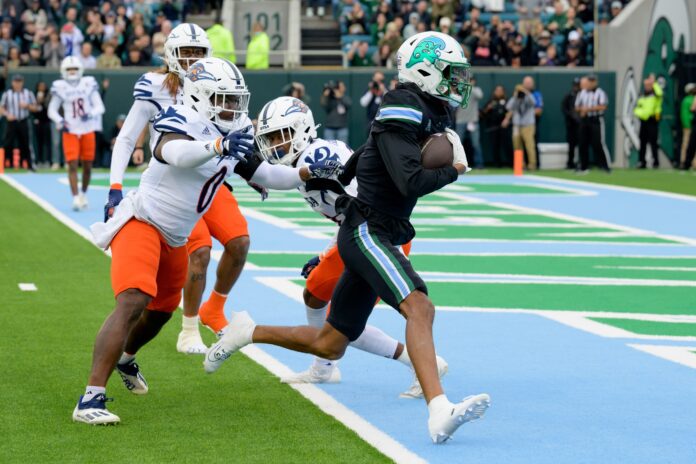 Tulane Green Wave wide receiver Chris Brazzell II (17) runs around UTSA Roadrunners defensive back Ken Robinson (21) for a touchdown during the first half at Yulman Stadium.