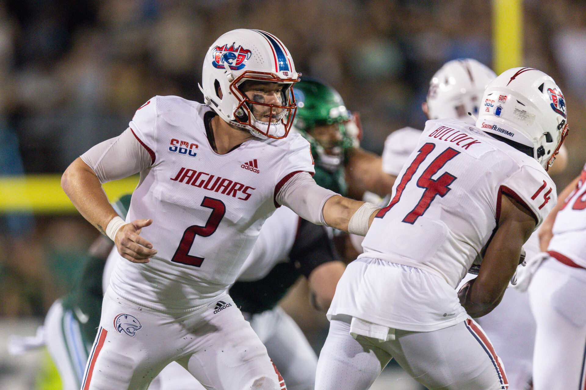 South Alabama Jaguars quarterback Carter Bradley (2) hands the ball off to South Alabama Jaguars running back Kentrel Bullock (14) against the Tulane Green Wave during the first half at Yulman Stadium.