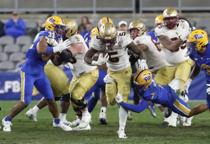 Boston College Eagles running back Kye Robichaux (5) runs the ball against the Pittsburgh Panthers during the third quarter at Acrisure Stadium.