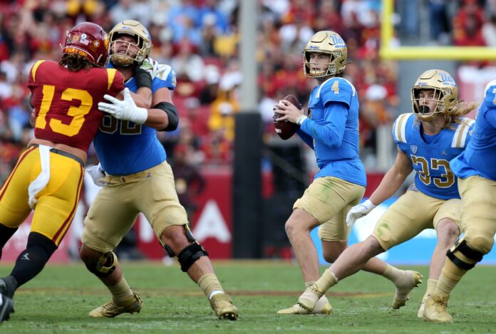 UCLA Bruins quarterback Ethan Garbers (4) drops to throw during the first quarter against the USC Trojans at United Airlines Field at Los Angeles Memorial Coliseum.