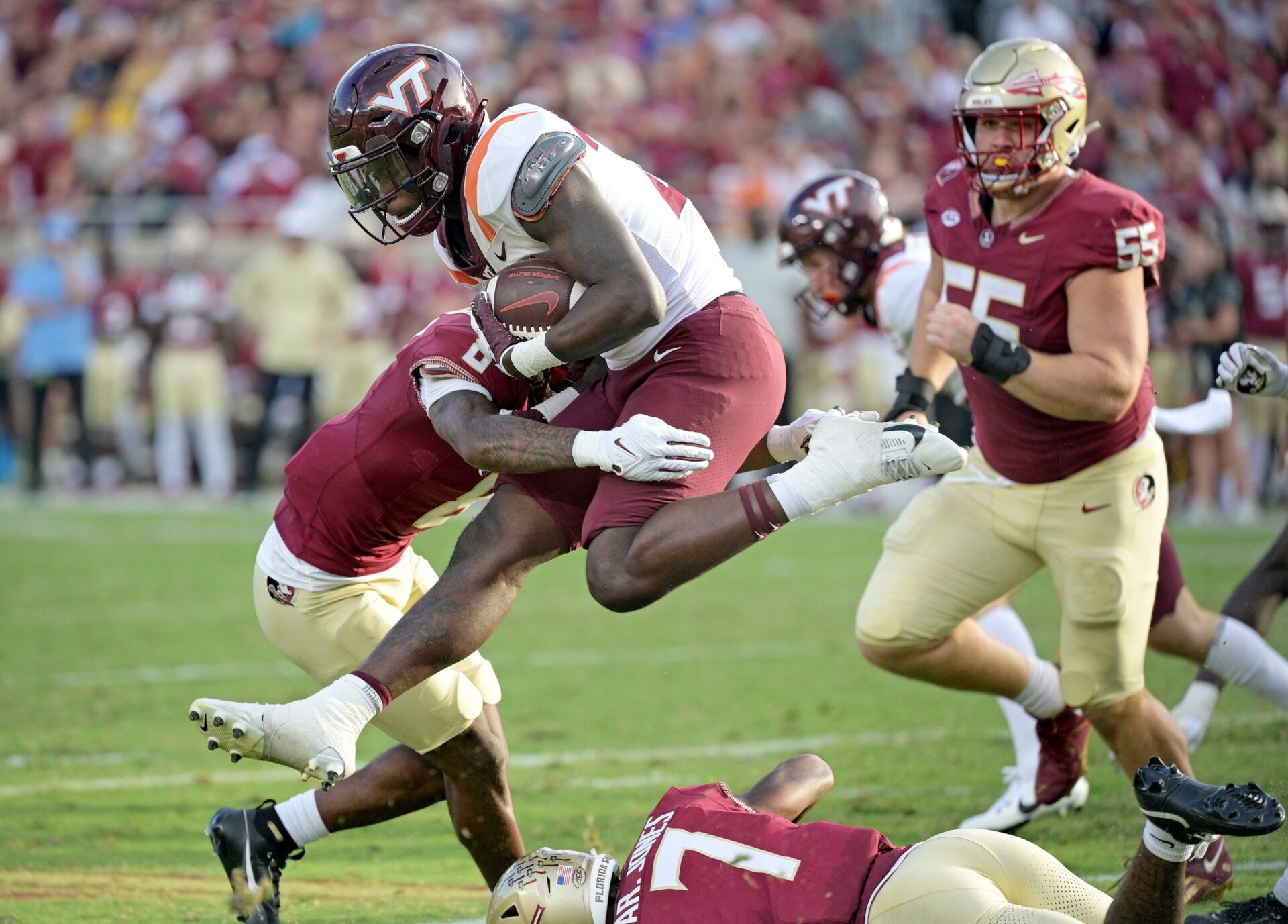 Virginia Tech Hokies running back Malachi Thomas (24) leaps against a Florida State Seminoles defender during the second half at Doak S. Campbell Stadium.