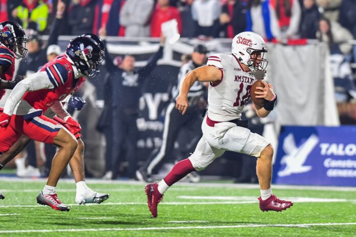 New Mexico State Aggies quarterback Diego Pavia (10) runs for a touchdown during the first quarter against the Liberty Flames at Williams Stadium.