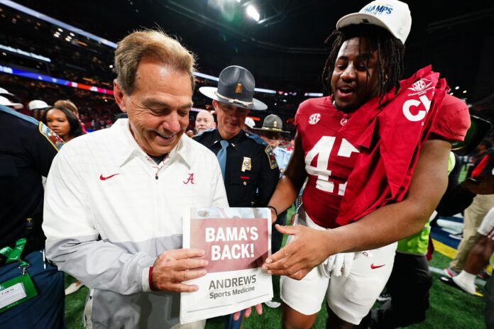 Alabama Crimson Tide head coach Nick Saban celebrates with defensive lineman James Smith (47) after defeating the Georgia Bulldogs in the SEC Championship at Mercedes-Benz Stadium.