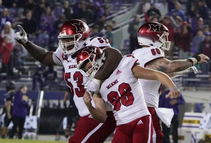 Miami (Ohio) Redhawks place kicker Graham Nicholson (98) celebrates the game winning field goal with offensive lineman Caleb Shaffer (53) against the Northwestern Wildcats during the second half at Ryan Field.