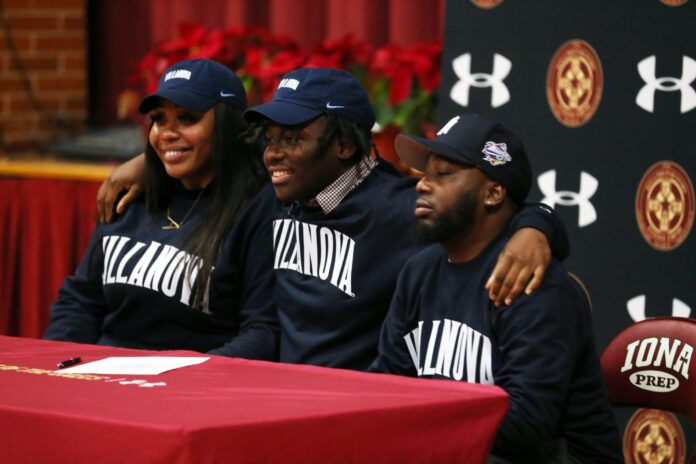 Iona Prep's Capri Martin signs his National Letter of Intent to play football at Villanova University, while at a ceremony in the gym at Iona Prep in New Rochelle Dec. 21, 2022.