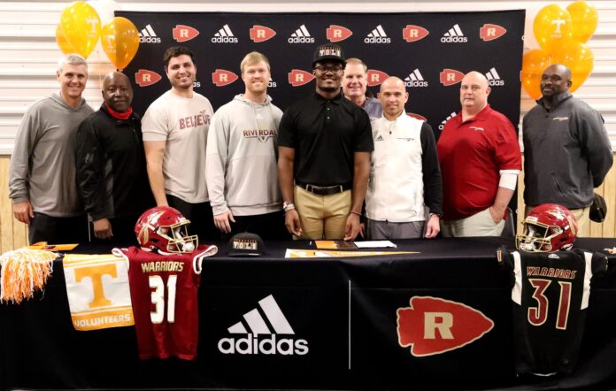 Riverdale football player Elijah Herring has his photo taken with his Riverdale coaches after he signed to play football with the University of Tennessee on Thursday, Dec. 16, 2021, at Riverdale.