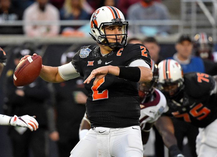 Dec 28, 2017; Orlando, FL, USA; Oklahoma State Cowboys quarterback Mason Rudolph (2) attempts a pass against the Virginia Tech Hokies during the first half in the 2017 Camping World Bowl at Camping World Stadium. Mandatory Credit: Jasen Vinlove-USA TODAY Sports