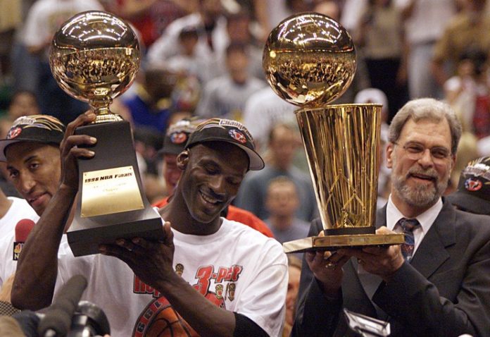 Michael Jordan and Phil Jackson celebrate after finishing off the Jazz to win the 1998 championship. 2020-04-16 Jordan Jackson