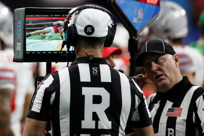The referee reviews a critical first down play from Georgia tight end Brock Bowers (19) during the second half of the Chick-fil-A Peach Bowl NCAA College Football Playoff semifinal game between Ohio State and Georgia on Saturday, Dec 31, 2022, in Atlanta. Georgia won 42-41. News Joshua L Jones